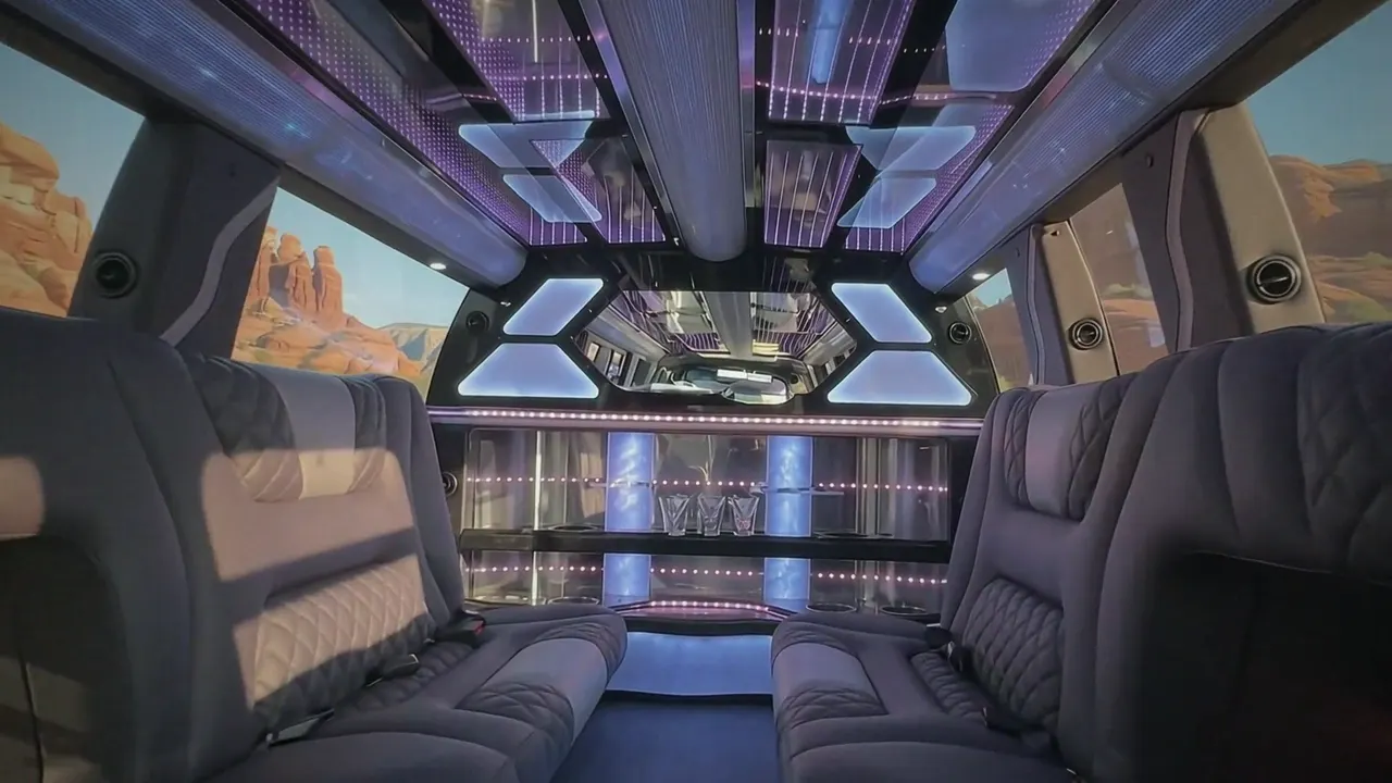Inside the Cadillac Escalade limo in Fort Lupton: LED light-show ceiling, leather lounge seating and lit bar